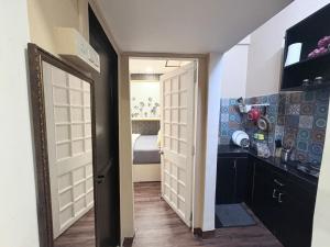 a hallway with two white doors and a bedroom at 1BHK CASA BELLA Off Linking rd Ground floor in Mumbai