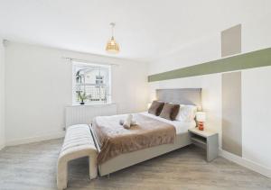 a white bedroom with a large bed and a window at Elegant 3-Bed Near Station, Pantiles & Calverley in Royal Tunbridge Wells