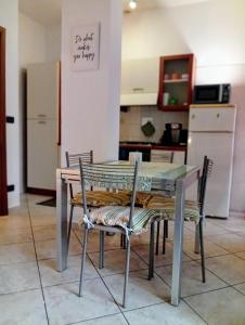 a table and chairs in a kitchen with a refrigerator at B&B Rivoli in Rivoli