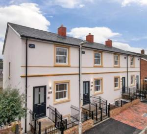 a white house with black doors and fences at Elegant 3-Bed Near Station, Pantiles & Calverley in Royal Tunbridge Wells