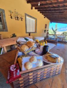 a basket filled with lots of different types of bread at Chales Estância Verdejante in Sapucaí-Mirim