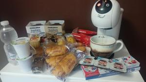 a table with a coffee maker and a cup of coffee at Vialetto v. Pastro 10 in Milan