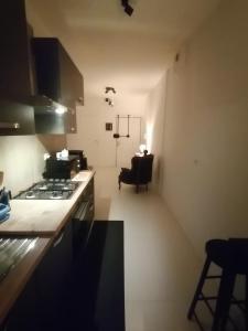 a kitchen with a stove and a chair in a room at Urban Suite- Holiday Rooms in Padova