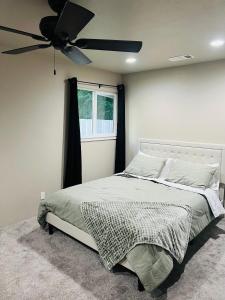 a bedroom with a bed with a ceiling fan at Rest and Retreat River House in Grants Pass
