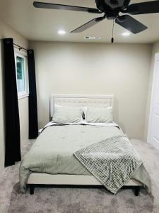 a bedroom with a bed with a ceiling fan at Rest and Retreat River House in Grants Pass