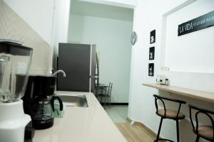 a kitchen with a counter with a mixer and two chairs at CASA ROOSEVELT in Cali
