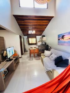 a living room with a couch and a table at Chale Pitanga 38 in Pipa