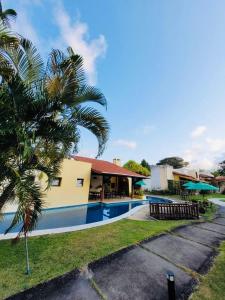 a resort with a swimming pool next to a building at Chale Pitanga 38 in Pipa