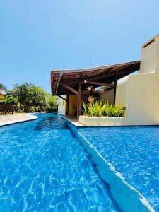 a swimming pool in front of a villa at Chale Pitanga 38 in Pipa