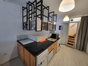 una cucina con piano di lavoro nero in una camera di Loft marsa cube vue panoramique vue mer a La Marsa Altre 35 foto