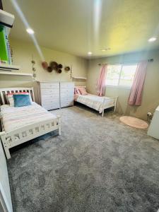 a bedroom with two beds and a window at Rest and Retreat River House in Grants Pass +20 photos