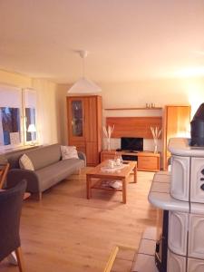 a living room with a couch and a table at Casa Lobi - Die Ferienwohnung mit Ausblick! in Korbach