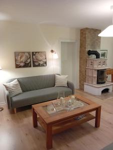 a living room with a couch and a coffee table at Casa Lobi - Die Ferienwohnung mit Ausblick! in Korbach
