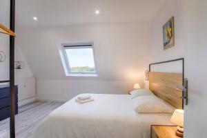 Ένα ή περισσότερα κρεβάτια σε δωμάτιο στο Bel Appartement Cabourg