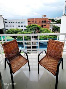 two wicker chairs sitting on top of a balcony at CHIPICHAPE INN in Cali