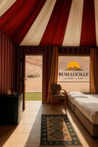 a room with a tent with a bed and a chair at RUM LUCILLE lUXURY CAMP in Wadi Rum