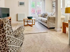 een woonkamer met een bank en een tafel bij The Police Station - Uk45642 in Silloth