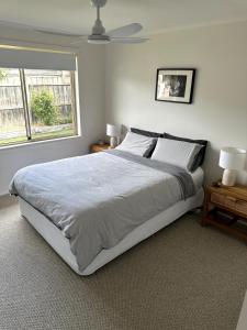 a bedroom with a large bed and a window at Beach Escape Torquay in Torquay +9 photos