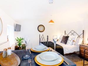 una sala de estar con una mesa con platos. en Tor View-Uk34415, en Cheddar