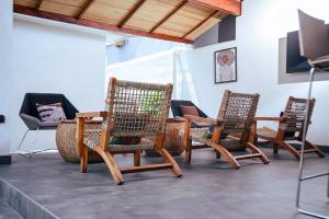 a group of chairs and a table in a room at Ahomé Guest house & Lounge in Lomé