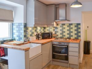 a kitchen with a sink and a stove at Rosetta Apartments - Ocean Mist in Newquay
