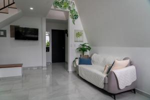 a living room with a couch and a tv at Gival Paradise in Fortuna