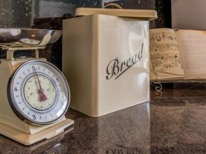 a clock sitting on a table next to a box at Littlebay Apartment in Oban