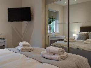 a room with towels on a bed with a mirror at Bowness Apartment - Uk11016 in Bowness-on-Windermere