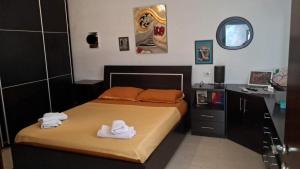 ein Schlafzimmer mit einem Bett mit Handtüchern darauf in der Unterkunft Leonora Lake View Apartment in Pogradec