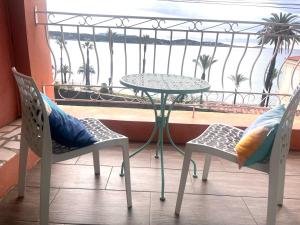 a table and two chairs and a table on a balcony at La routarde in Bandol