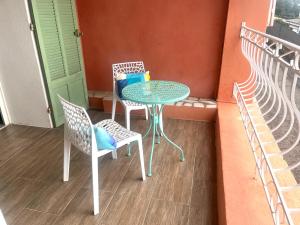 a table and chairs on a balcony with a table at La routarde in Bandol