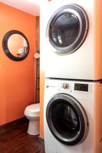 a washer and dryer in a bathroom with a toilet at Secluded Delight: Unplug and Reconnect in a Special House in Lake Toxaway's Woods in Indian Lake Estates