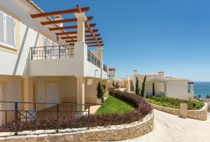 a villa with a view of the ocean at NAU Salema Beach Village in Salema