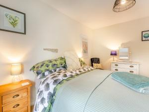 a bedroom with a bed and a dresser and a tv at Church View Cottage - Uk45697 in Pickering