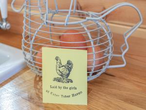 a sign next to a basket with a chicken at Cater Tober Haven in Dunnet +8 photos
