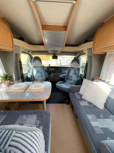an interior view of an rv with a table and chairs at Alojamiento dondequiera I in Breña Baja