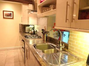 a kitchen with a sink and a stove at High White Stones in Ambleside
