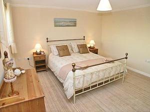 a bedroom with a large bed and two night stands at Breedsmoor Cottage in Ore