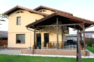 a house with a pavilion on the front of it at Casa Sofia in Livezeni
