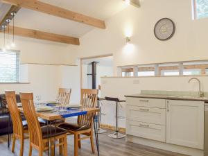 a kitchen and dining room with a table and chairs at Llety'r Saer in Pen-y-bont-fawr +20 photos