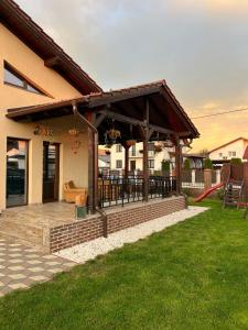 a pavilion with a deck in the backyard of a house at Casa Sofia in Livezeni