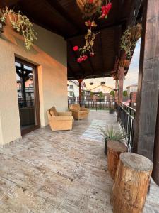 a patio with couches and chairs on a building at Casa Sofia in Livezeni