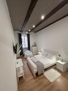 een slaapkamer met een groot wit bed en een raam bij Arco Antico in Alba