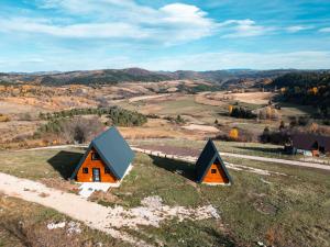 two small houses on top of a hill at Čarobna jutra Zlatara 2 in Radijevići +17 photos