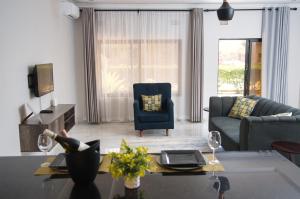 a living room with a couch and a table at Greendale Apartments in Lusaka