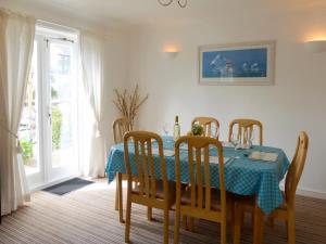 a dining room with a table with a blue table cloth at Spinnakers in Falmouth