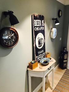 a table with a sign that says beer is cheaper than therapy at Cuco in Requena
