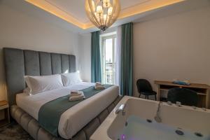 una camera d'albergo con un letto e una vasca da bagno di Mare Luxury a Napoli