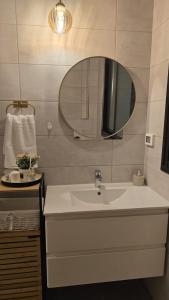 une salle de bain avec un lavabo et un miroir dans l'établissement Sunset Home, à Netanya