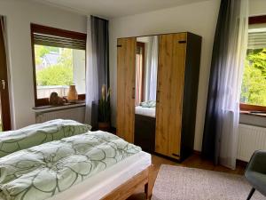 a bedroom with two beds and a mirror at FeWo Linneweber in Willingen